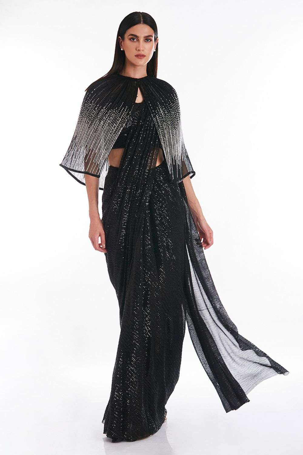 Slinky black shimmer lurex crêpe gown lavishly illustrated with the Ba