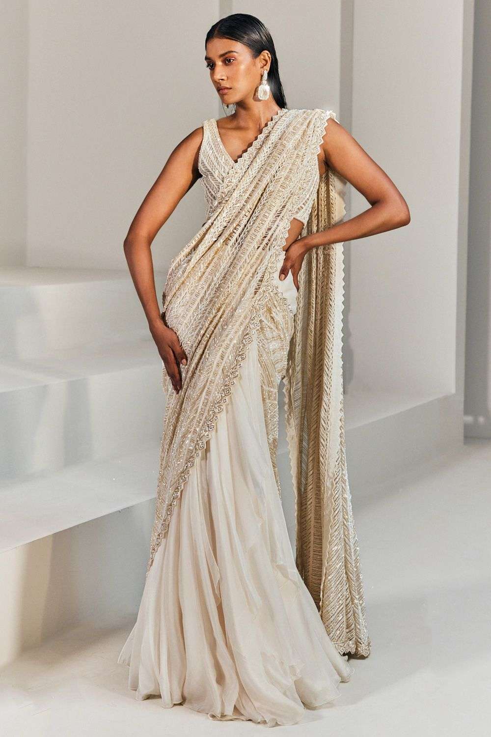 GOLD PRE STITCHED DRAPED SAREE WITH A HAND EMBROIDERED BLOUSE, EMBOSSED  FABRIC PALLU AND A SHOULDER BROACH DETAIL. - Seasons India